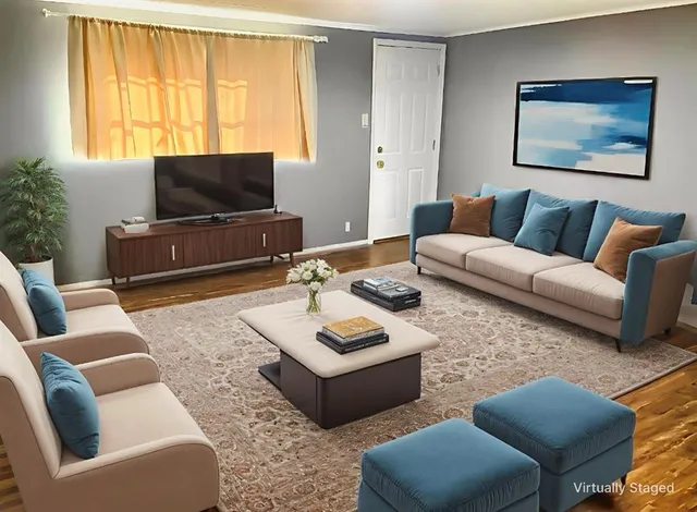 a living room with furniture a flat screen tv and a large window