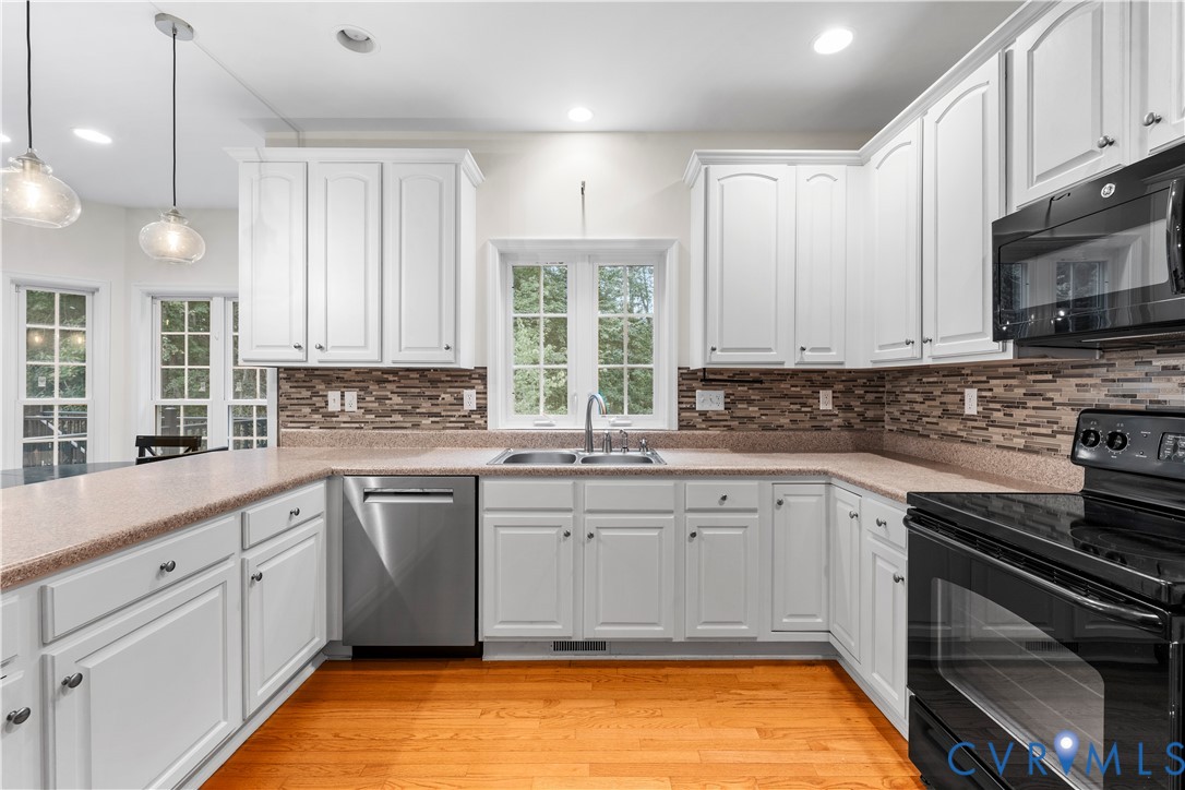 1301 Hawkins Wood Circle Midlothian, VA 23114 - Photo 12 of 50 a kitchen with a sink stove and cabinets