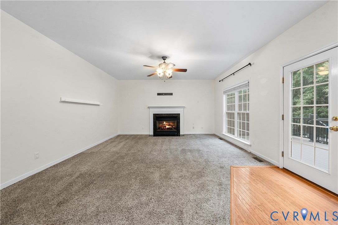 1301 Hawkins Wood Circle Midlothian, VA 23114 - Photo 15 of 50 a view of an empty room with a fireplace and a window