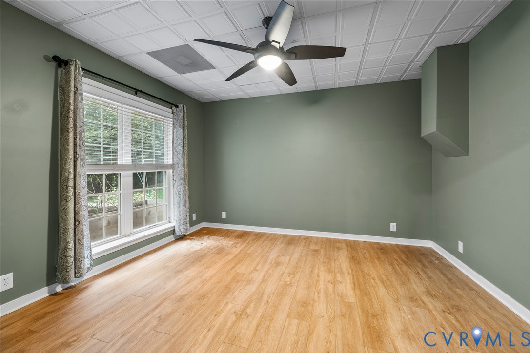 1301 Hawkins Wood Circle Midlothian, VA 23114 - Photo 25 of 50 a view of an empty room with a window and wooden floor
