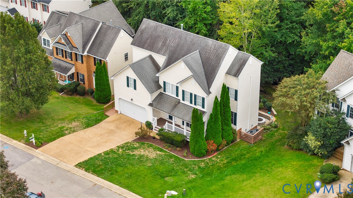 1301 Hawkins Wood Circle Midlothian, VA 23114 - Photo 3 of 50 a aerial view of a house with a yard table and chairs