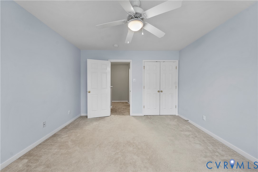 1301 Hawkins Wood Circle Midlothian, VA 23114 - Photo 34 of 50 an empty room with a ceiling fan and a window