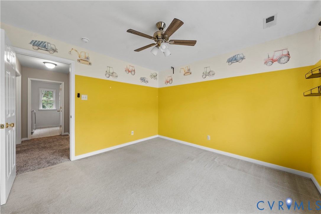 1301 Hawkins Wood Circle Midlothian, VA 23114 - Photo 38 of 50 a view of an empty room with a ceiling fan and a refrigerator