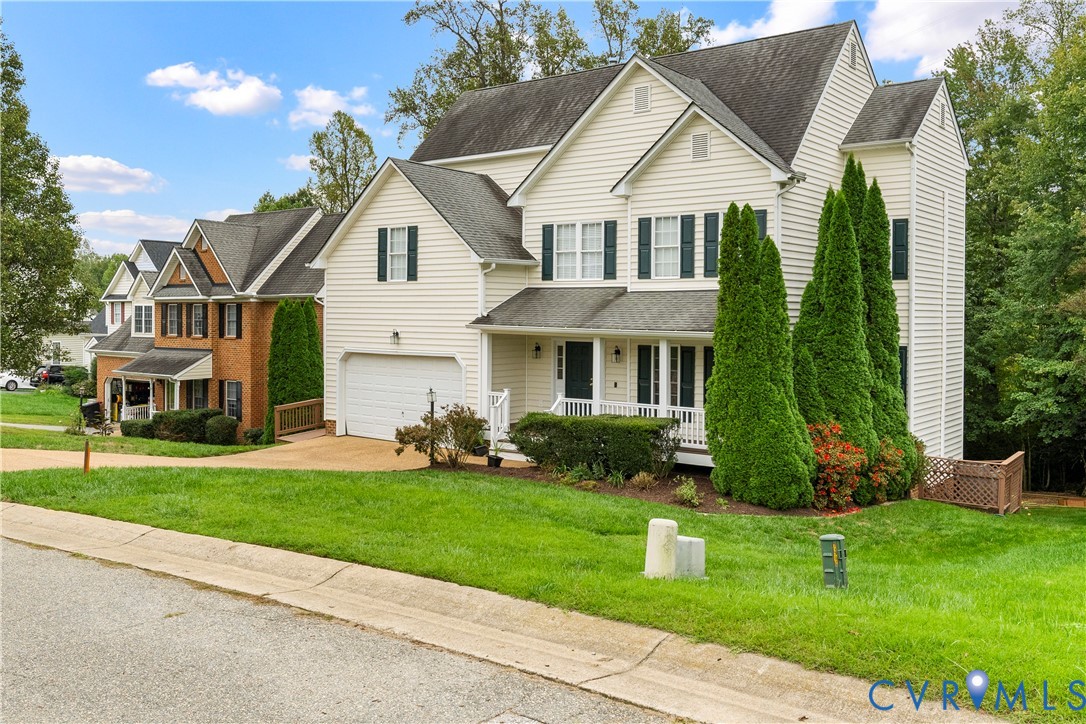 1301 Hawkins Wood Circle Midlothian, VA 23114 - Photo 4 of 50 a front view of a house with a yard and garage