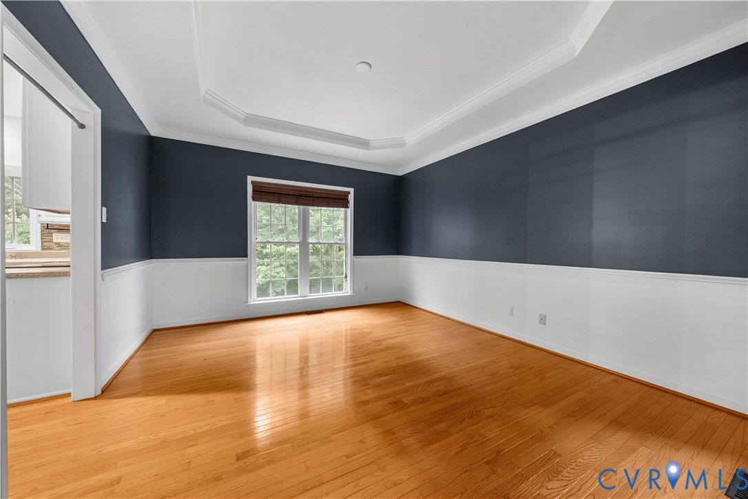 1301 Hawkins Wood Circle Midlothian, VA 23114 - Photo 9 of 50 a view of an empty room with wooden floor and a window