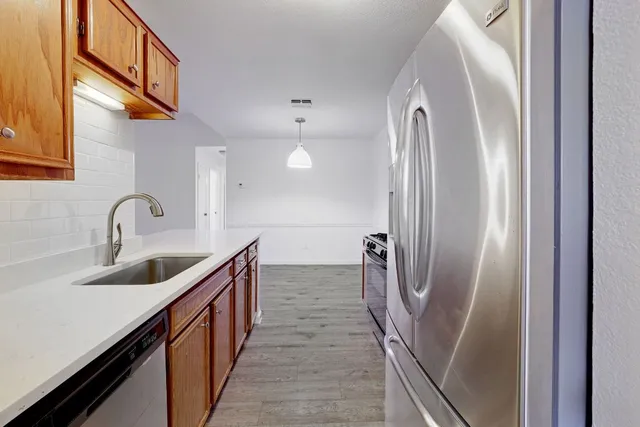 a kitchen with stainless steel appliances a sink and a stove