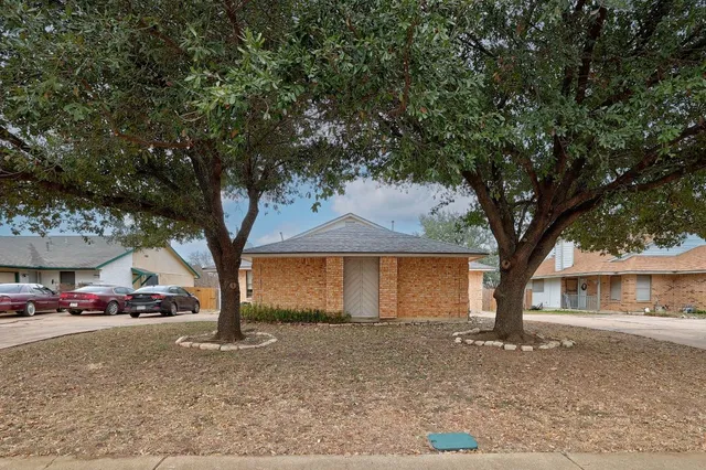 a view of house with outdoor space and trees