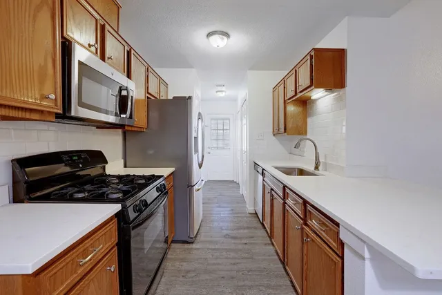 an empty room with wooden floor and window