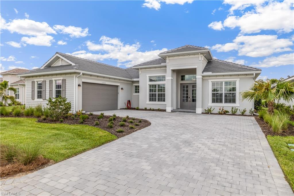 15977 Cranes Marsh Court Babcock Ranch, FL 33982 - Photo 2 of 24 a front view of a house with garden