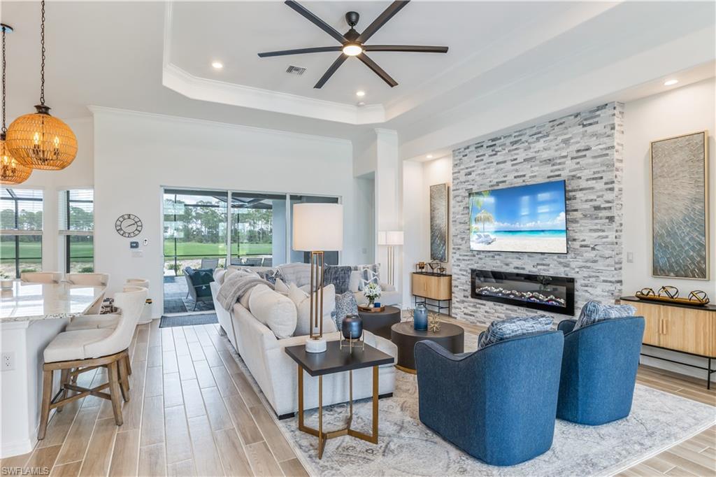 15977 Cranes Marsh Court Babcock Ranch, FL 33982 - Photo 7 of 24 a living room with fireplace furniture and a large window