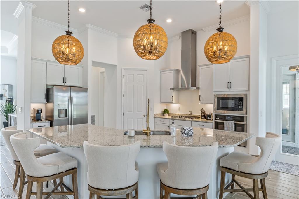 15977 Cranes Marsh Court Babcock Ranch, FL 33982 - Photo 9 of 24 a view of kitchen with dining table and chairs