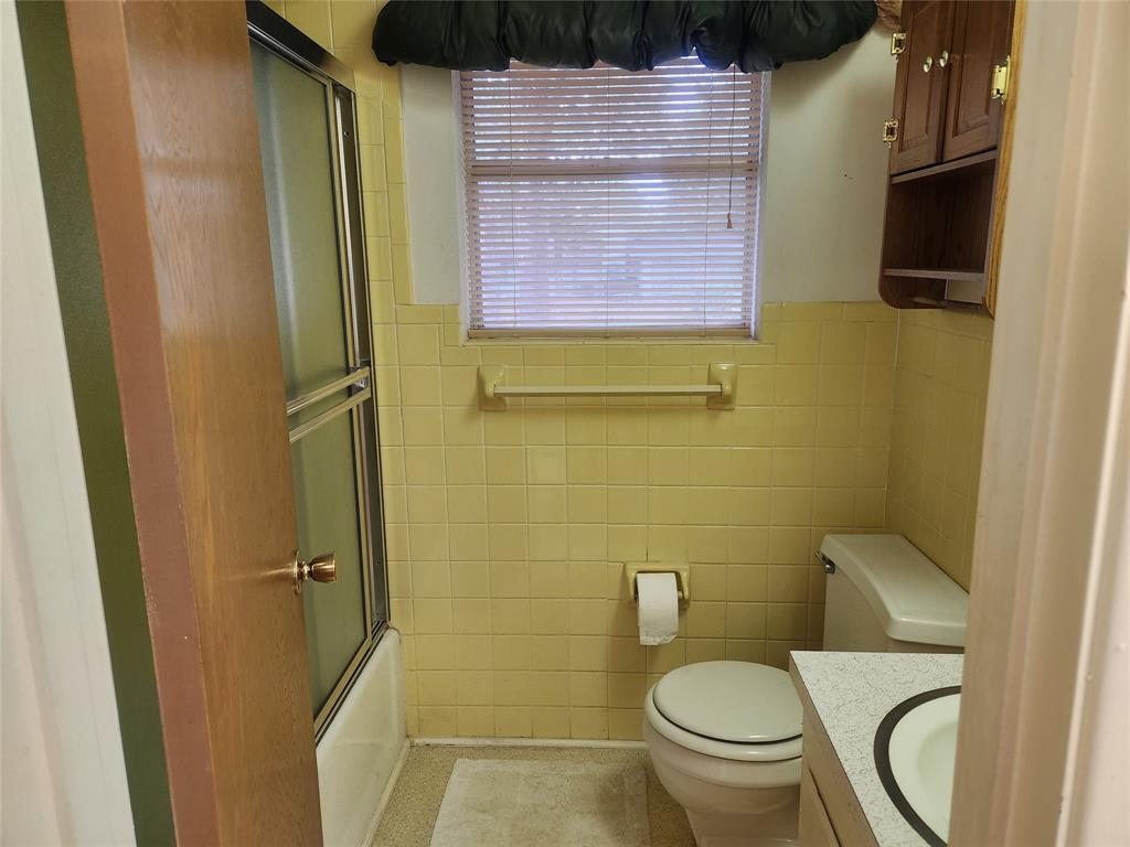 2821 Mccarley Drive Commerce, TX 75428 - Photo 18 of 32 a bathroom with a toilet a sink and a shower