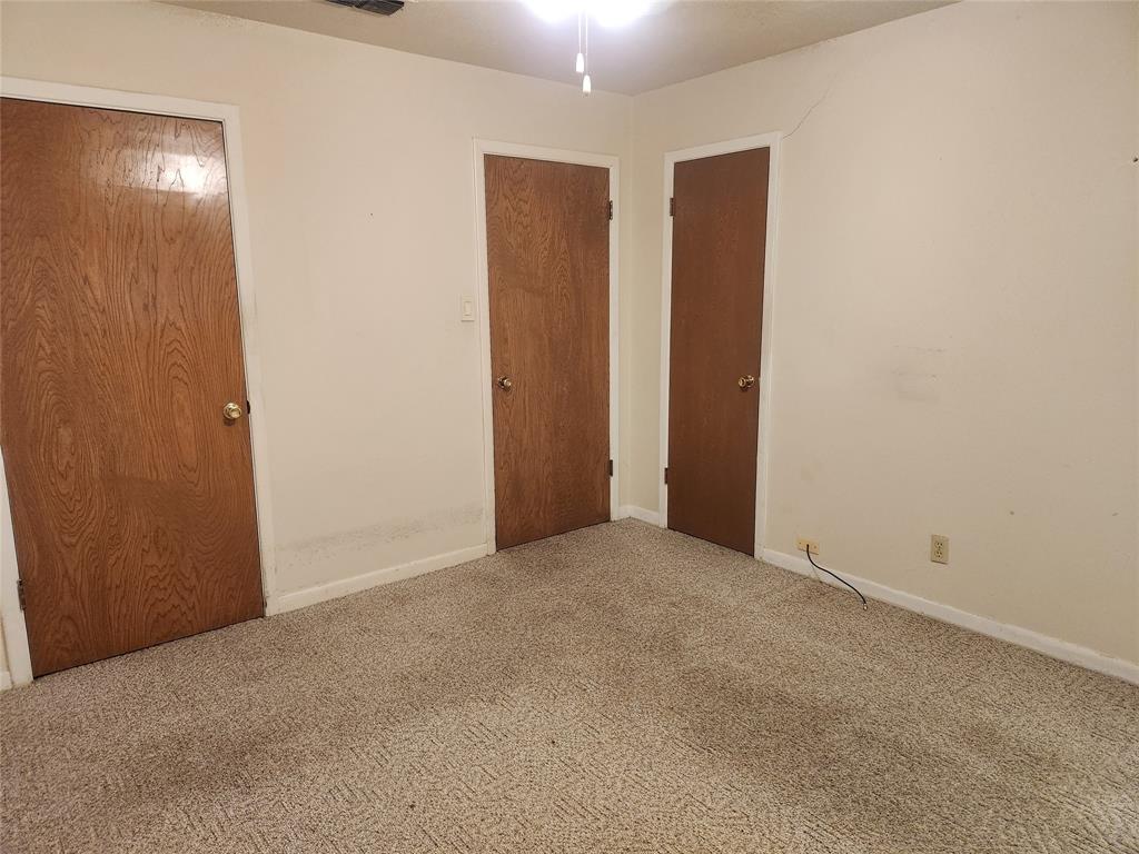 2821 Mccarley Drive Commerce, TX 75428 - Photo 25 of 32 an empty room with closet and mirror