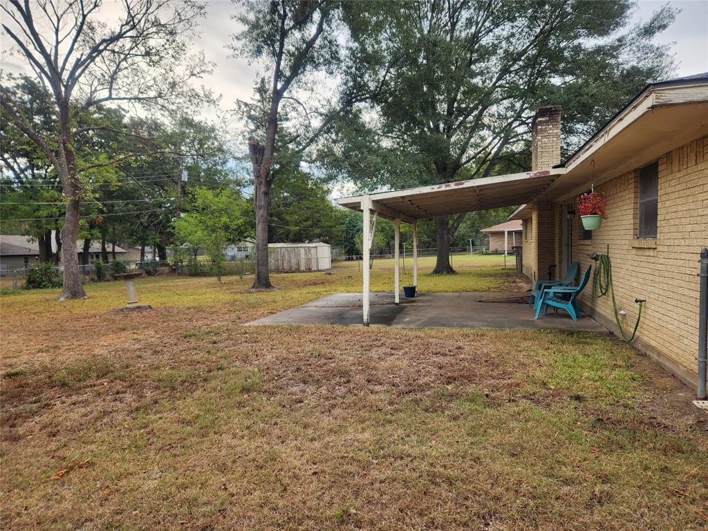 2821 Mccarley Drive Commerce, TX 75428 - Photo 3 of 32 a view of a house with backyard and a tree