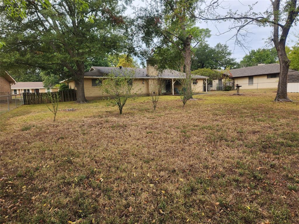 2821 Mccarley Drive Commerce, TX 75428 - Photo 6 of 32 a front view of a house with a yard