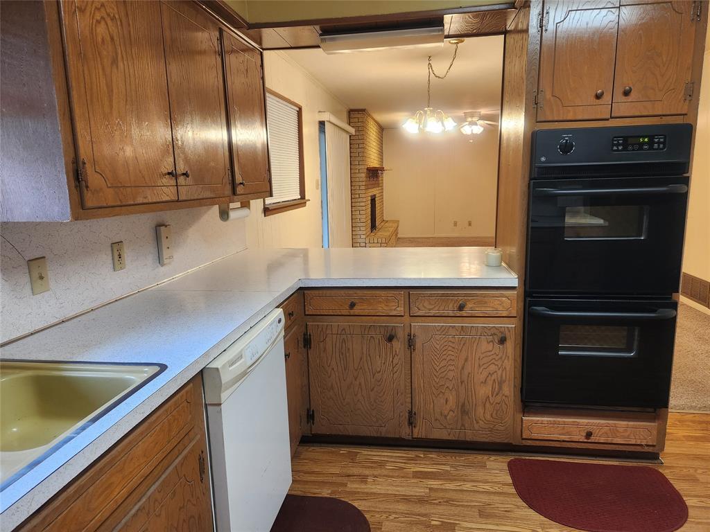 2821 Mccarley Drive Commerce, TX 75428 - Photo 10 of 32 a kitchen with stainless steel appliances granite countertop a sink a stove and a refrigerator