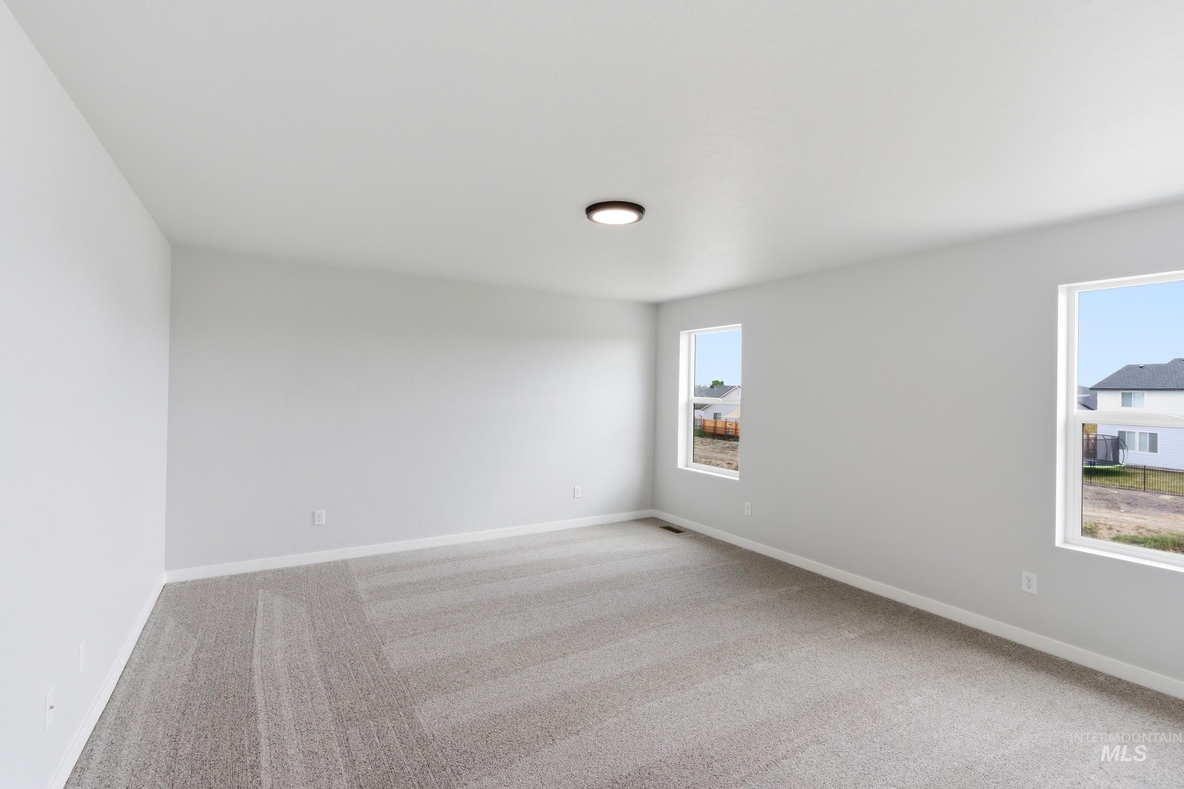 16558 Dunning Way Caldwell, ID 83607 - Photo 24 of 35 Spacious room featuring neutral carpeting and light gray wall paint