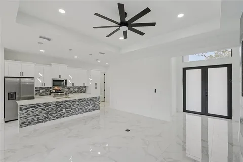 a kitchen with stainless steel appliances a refrigerator sink and microwave