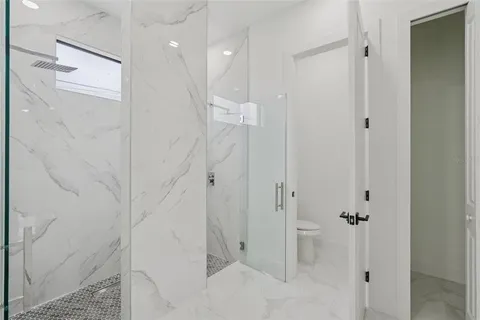 a view of a hallway with closet and a large window