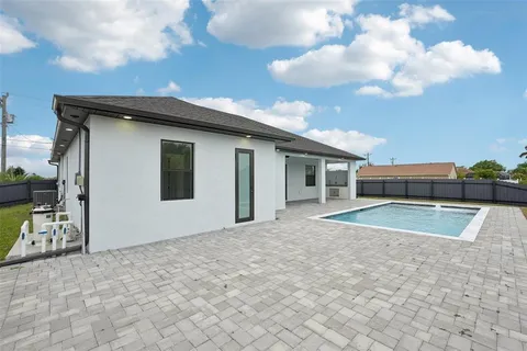 a view of a house with a backyard and a yard
