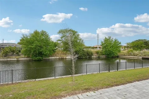 an aerial view of a house with outdoor space and lake view