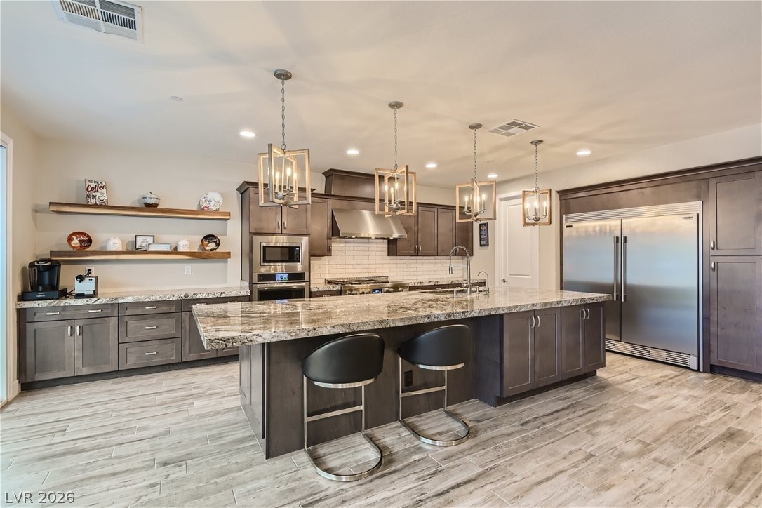 4631 Amazing View Street Las Vegas, NV 89129 - Photo 2 of 33 Culinary aspirations find a home in this well-appointed kitchen featuring abundant storage and a generous island.