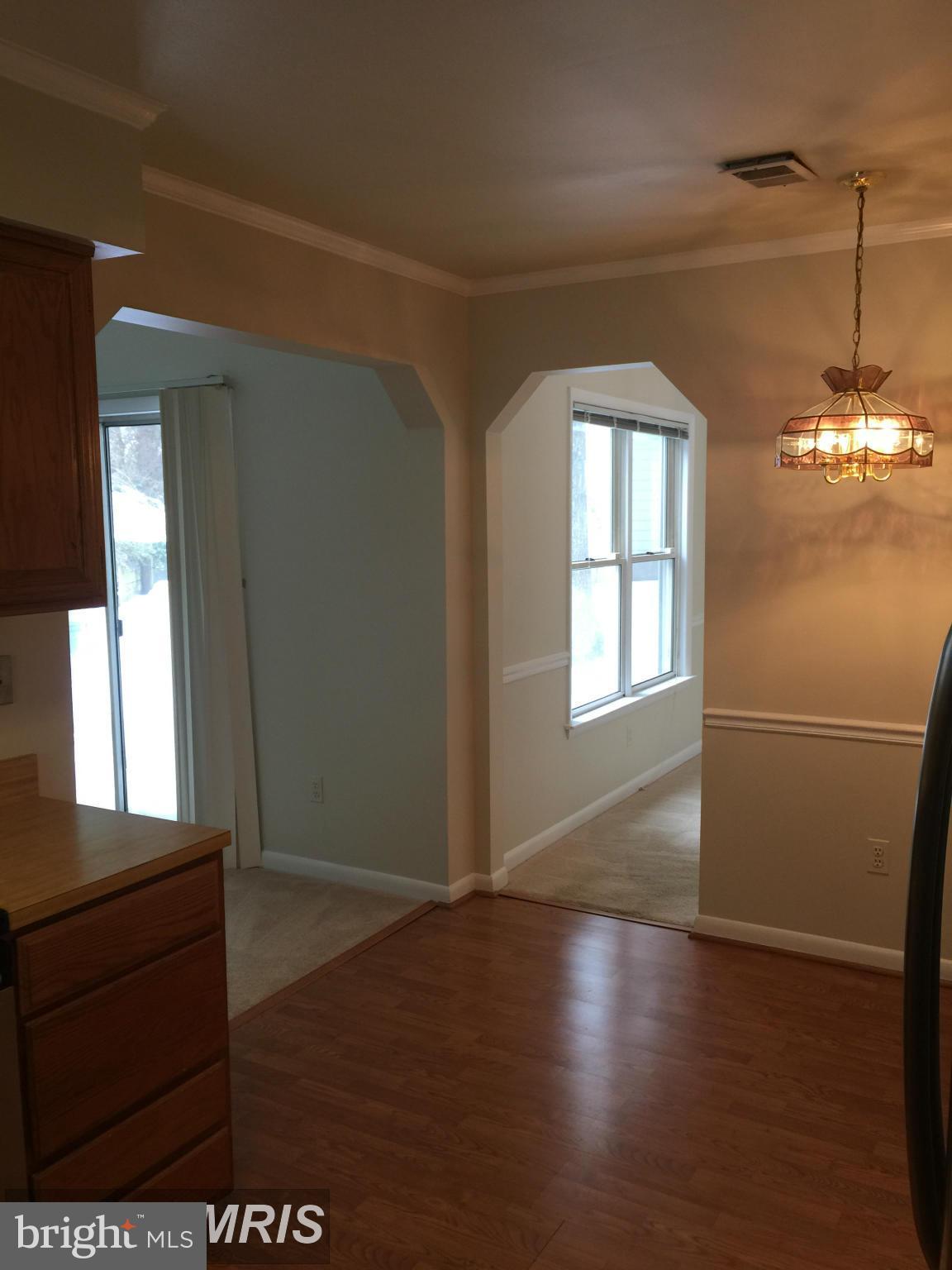 6249 Light Point Place Columbia, MD 21045 - Photo 11 of 18 a view of a room with wooden floor and windows