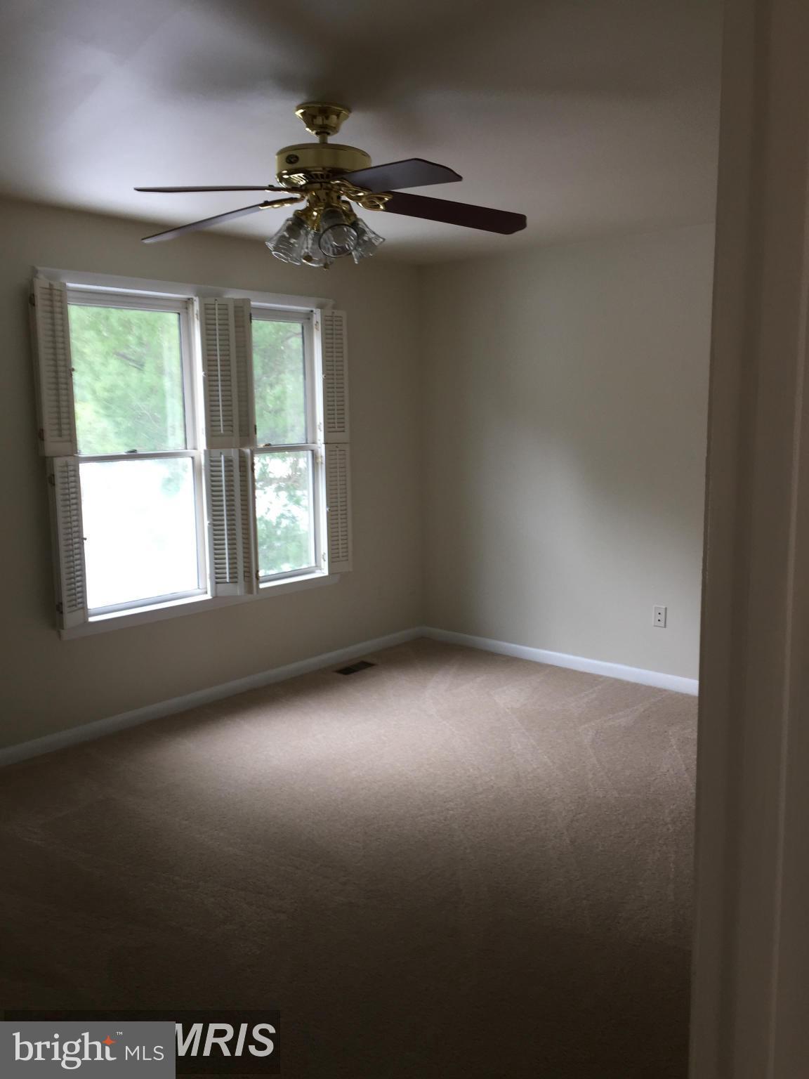 6249 Light Point Place Columbia, MD 21045 - Photo 15 of 18 an empty room with windows and fan