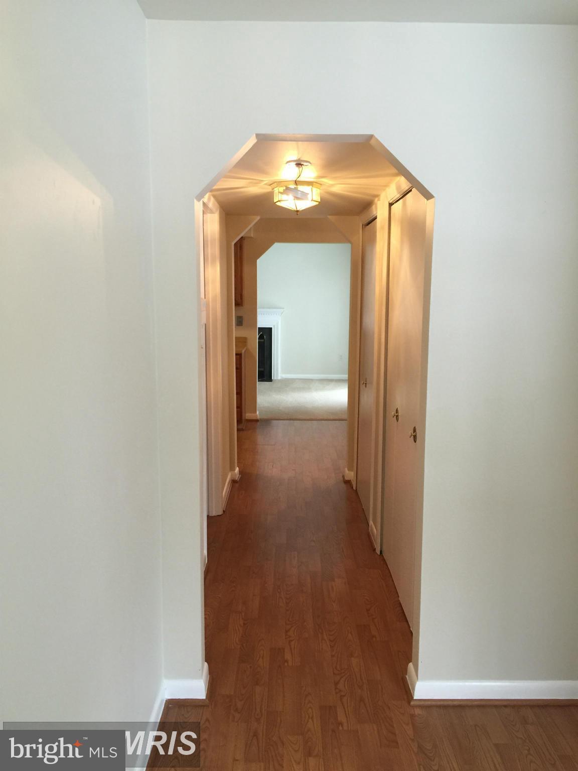 6249 Light Point Place Columbia, MD 21045 - Photo 4 of 18 a view of a hallway with wooden floor