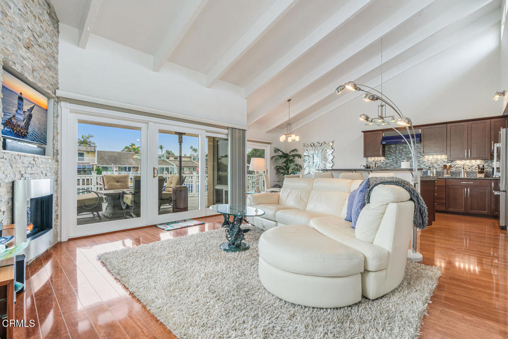 4604 Falkirk Bay Oxnard, CA 93035 - Photo 8 of 40 a living room with furniture a fireplace and a flat screen tv