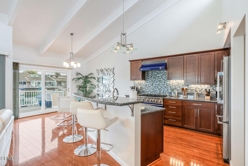 4604 Falkirk Bay Oxnard, CA 93035 - Photo 10 of 40 a kitchen with stainless steel appliances granite countertop a stove a sink and a refrigerator