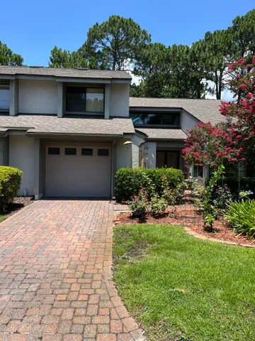 a front view of a house with a yard and a garage