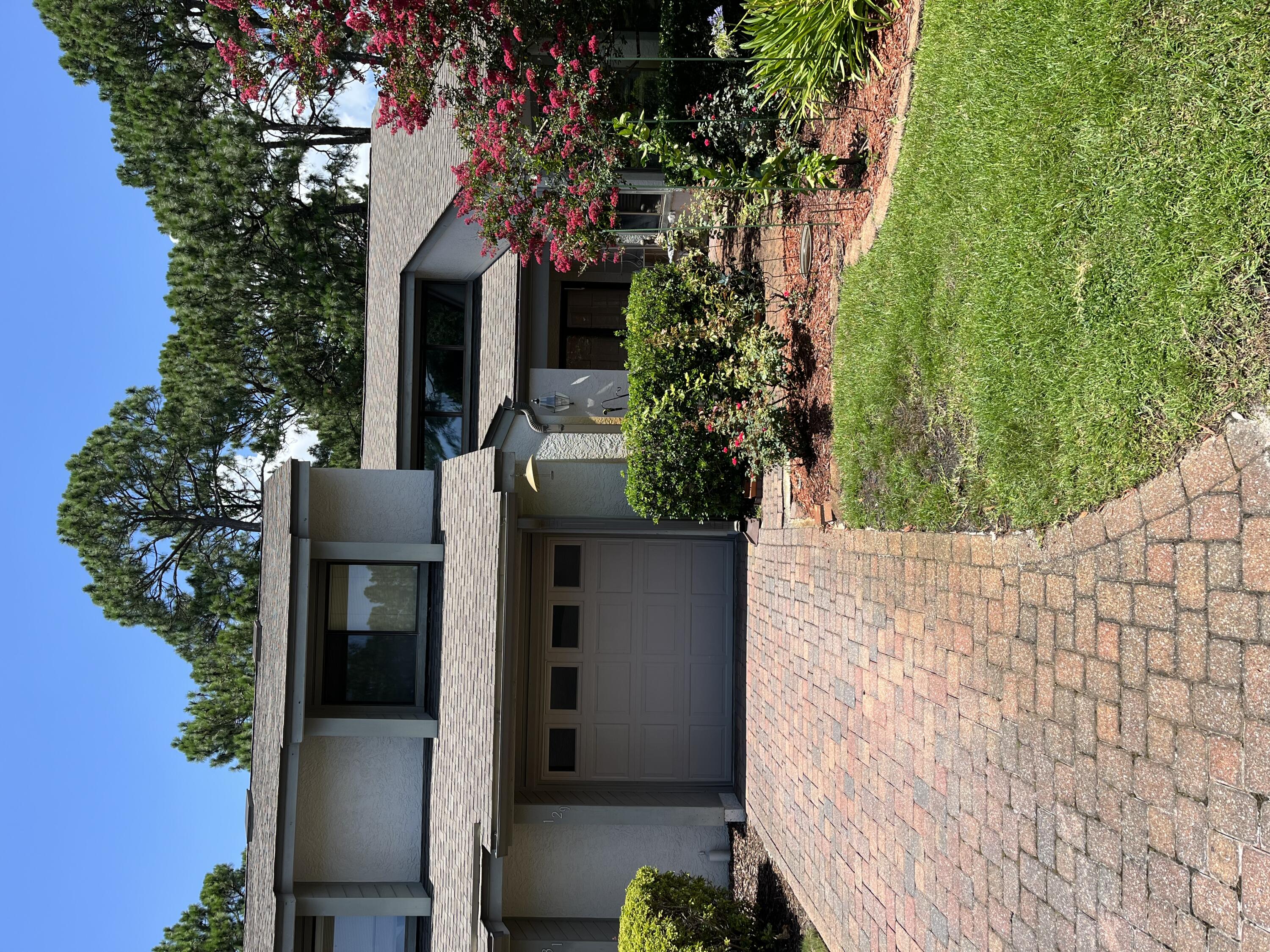 a front view of a house with a yard and a garage