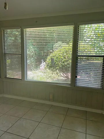 a view of empty room with fireplace and fan