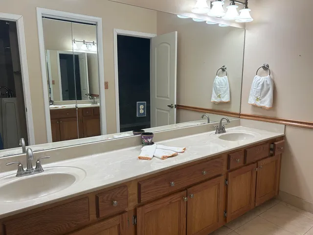 a view of a livingroom with wooden floor and a ceiling fan