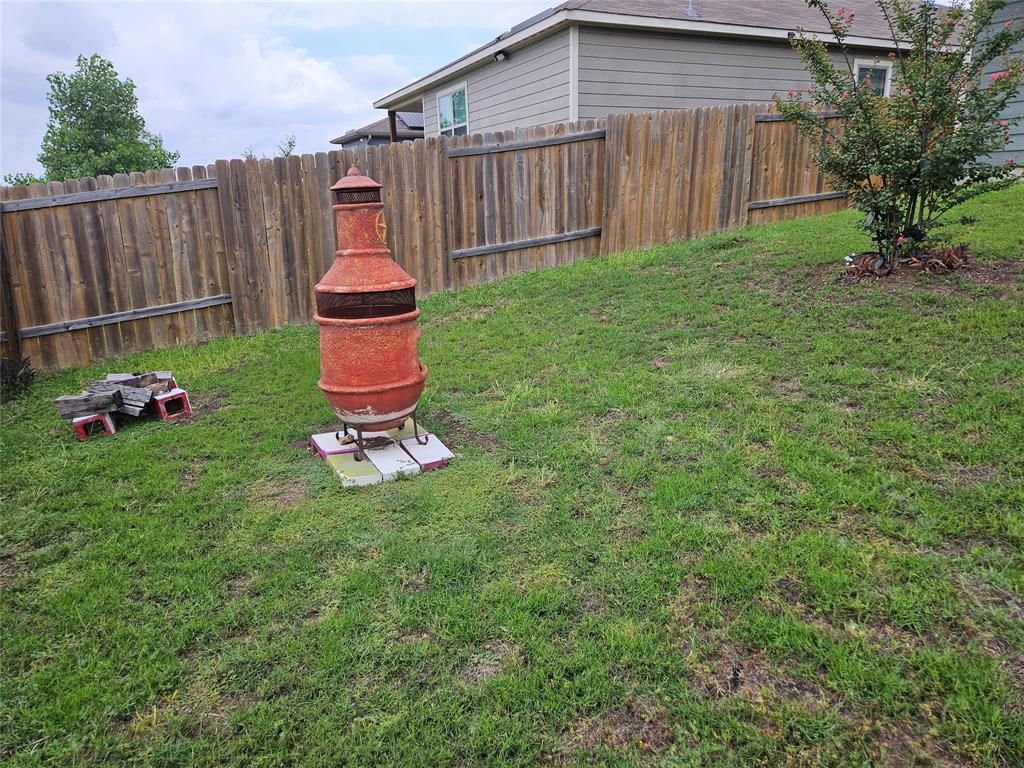 14262 Wrangler Way Dallas, TX 75253 - Photo 23 of 23 a backyard of a house with table and chairs