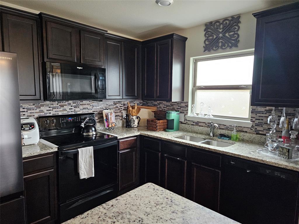 14262 Wrangler Way Dallas, TX 75253 - Photo 7 of 23 a kitchen with a sink stove and cabinets