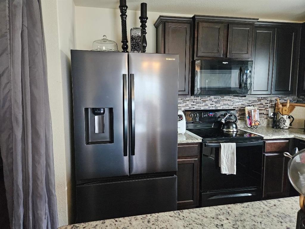 14262 Wrangler Way Dallas, TX 75253 - Photo 8 of 23 a metallic refrigerator freezer sitting in a kitchen