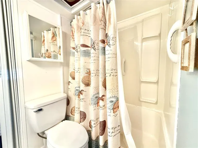 a white toilet sitting next to a bathroom sink