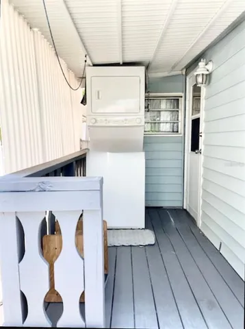 a view of balcony with wooden floor and outdoor seating