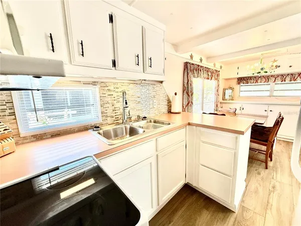 a kitchen with stainless steel appliances kitchen island granite countertop a sink and cabinets