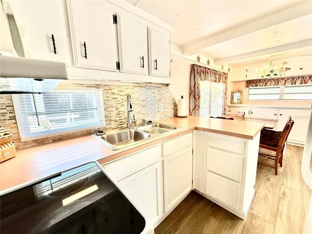 a kitchen with stainless steel appliances kitchen island granite countertop a sink and cabinets