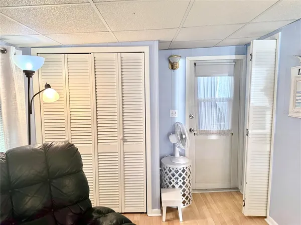 a view of a hallway with wooden floor and windows