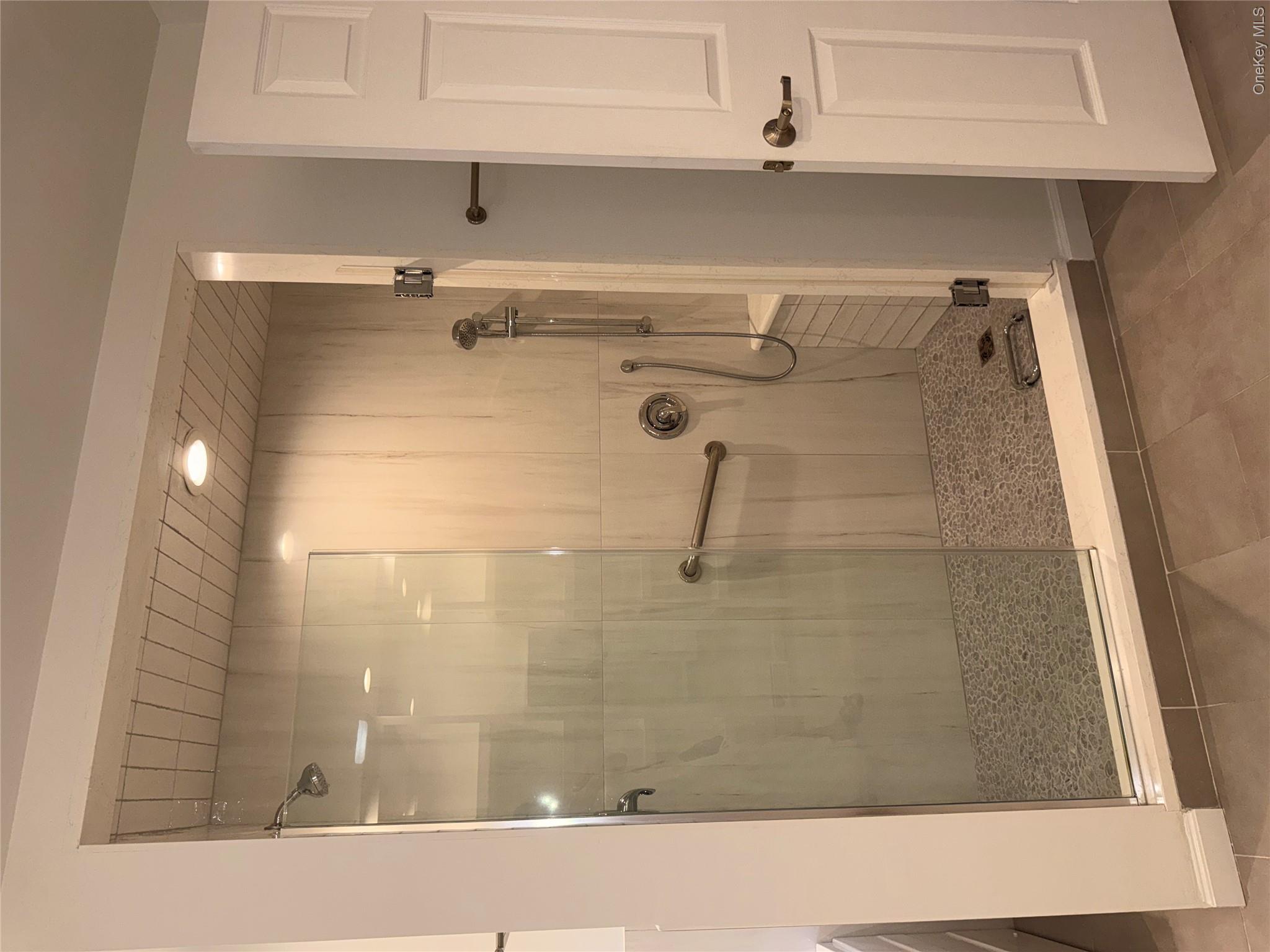 1661 Old Country Road, Unit 516 Riverhead, NY 11901 - Photo 42 of 50 a bathroom with a shower