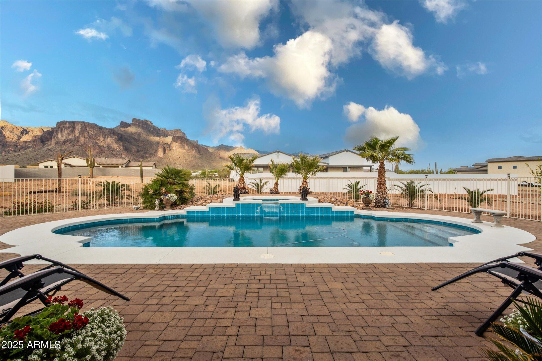 619 North Sun Road Apache Junction, AZ 85119 - Photo 10 of 72 a view of a swimming pool with a yard
