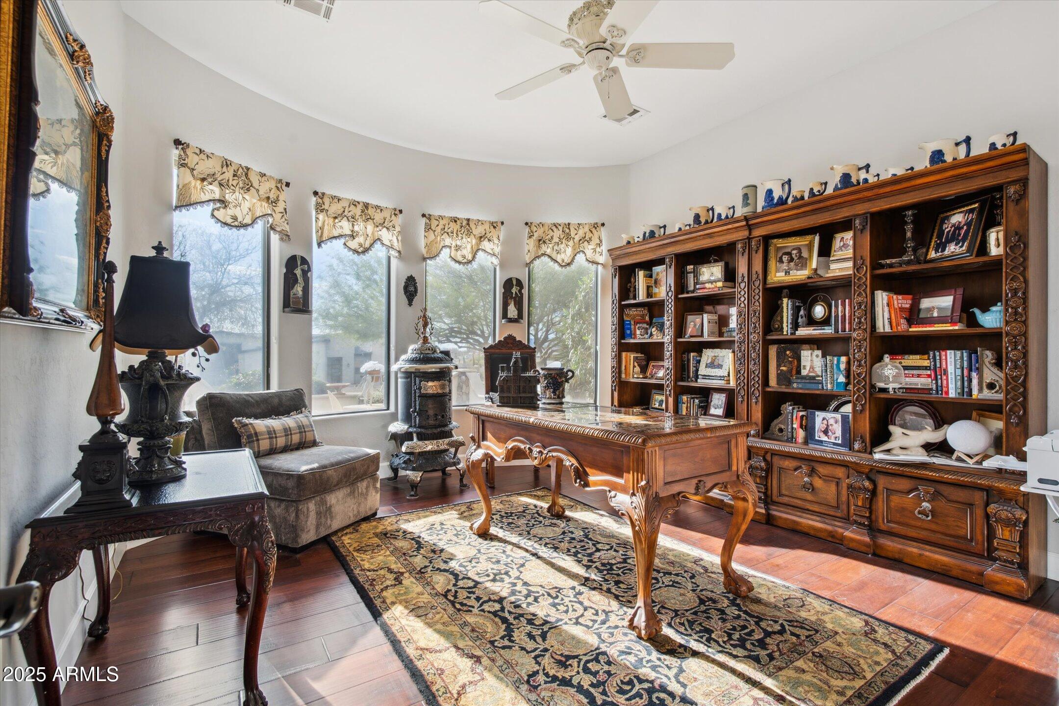 619 North Sun Road Apache Junction, AZ 85119 - Photo 33 of 72 a living room with furniture a rug and a book shelf
