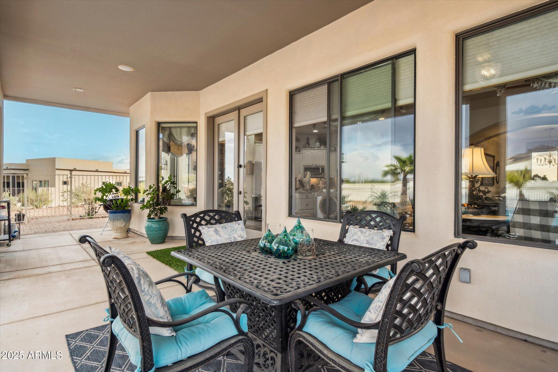 619 North Sun Road Apache Junction, AZ 85119 - Photo 54 of 72 a dining room with furniture a rug and a painting