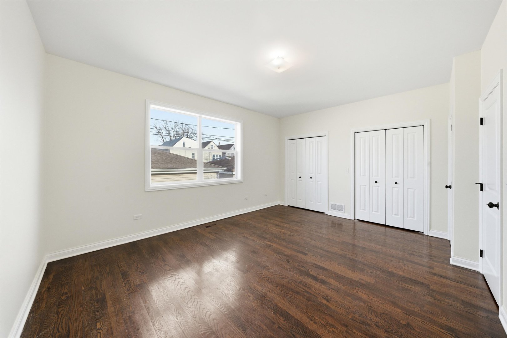 4063 South Rockwell Street Chicago, IL 60632 - Photo 12 of 24 an empty room with wooden floor and windows