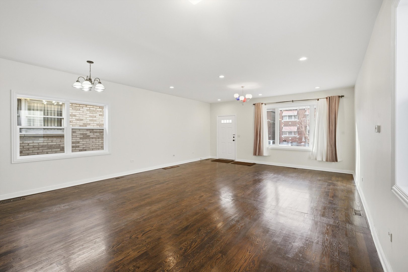 4063 South Rockwell Street Chicago, IL 60632 - Photo 7 of 24 an empty room with wooden floor cabinet and windows