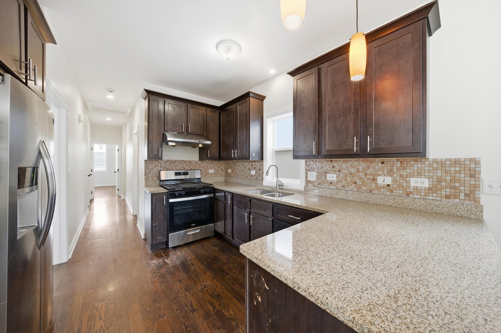 4063 South Rockwell Street Chicago, IL 60632 - Photo 8 of 24 a kitchen with stainless steel appliances granite countertop a sink stove and refrigerator